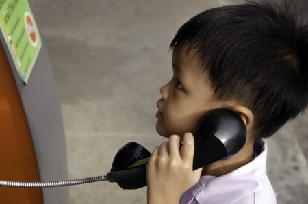 Boy talking on the phone accidentally の写真素材