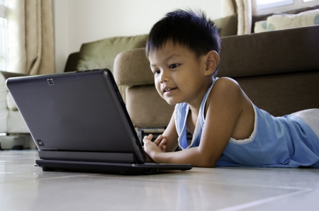 Kids having fun with a laptopの写真素材