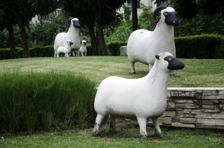 Statue decorated with sheep in the field.の写真素材