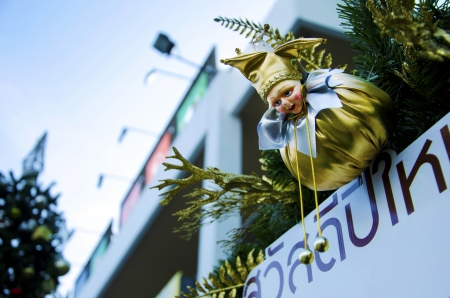 Doll decorated Christmas tree with the sky as a backdrop の写真素材