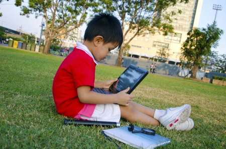 Child with notebook computers in the sky as a backdrop  の写真素材