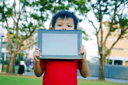 Child with notebook computers in the sky as a backdrop  の写真素材
