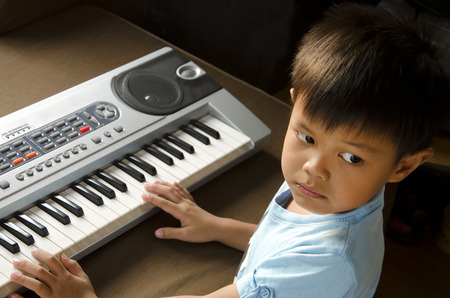 Young man using hands to play the Electone の写真素材
