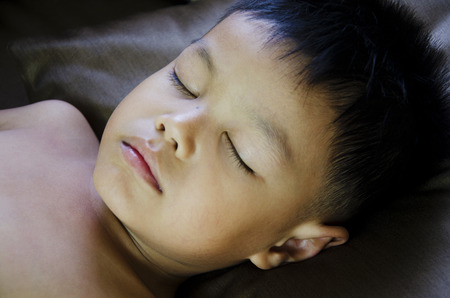 The boy was sleeping on the pillow  の写真素材