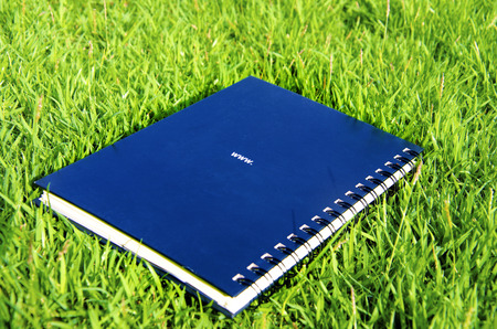 Image of a notebook with the rear of the lawn の写真素材
