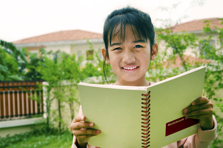 Kids and books With grass in the background の写真素材