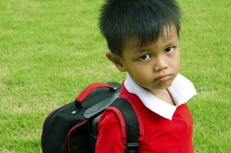 Kids school bag with grass in the background.の写真素材