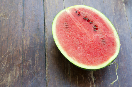 Melon on a wooden floor in the background.の写真素材