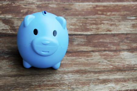 Pig piggy bank with a wooden floor in the background.の写真素材