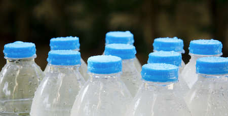 A drink bottle with water droplets on a black background.の写真素材