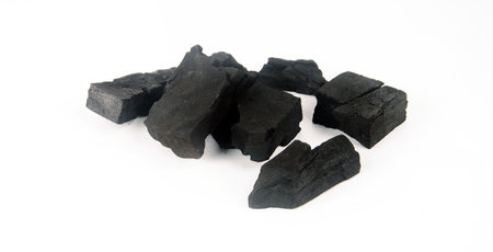 Black charcoal cubes on a white background.の写真素材