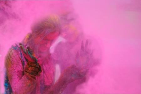 Two females standing in the fog of colors  gulal during Holi celebration in India の写真素材