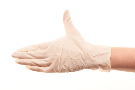 Close up of female doctor's hand in white sterilized surgical glove giving for handshake against white backgroundの写真素材