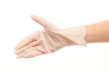 Close up of female doctor's hand in white sterilized surgical glove giving for handshake against white backgroundの写真素材