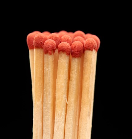 Group of red wooden matches isolated on black backgroundの写真素材