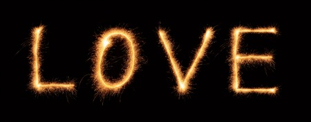 "Love" lettering drawn with bengali sparkles isolated on black backgroundの写真素材