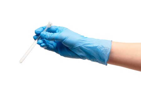 Close up of female doctor's hand in blue sterilized surgical glove holding transparent white glass ampoule with a drug against white backgroundの写真素材