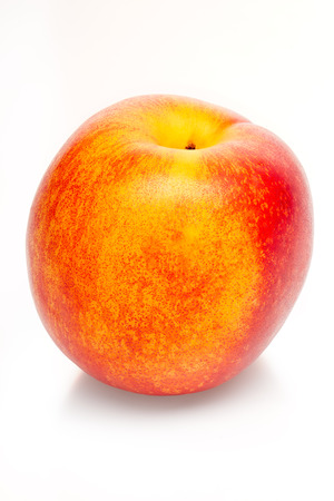 Two-colored orange and red peach isolated on white background. Clipping path includedの写真素材
