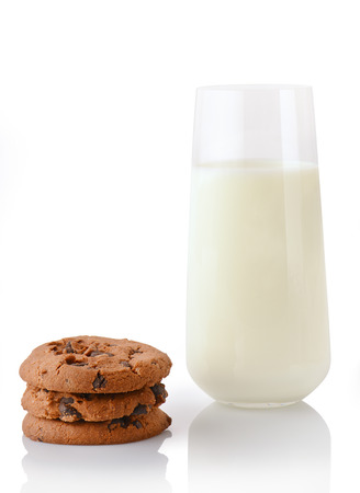 Stack of three homemade chocolate chip cookies and glass of milk, isolated on white backgroundの写真素材