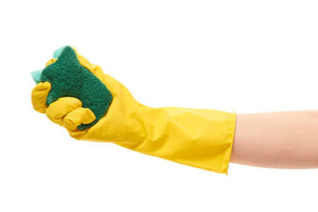 Close up of female hand in yellow protective rubber glove holding green cleaning sponge against white backgroundの写真素材