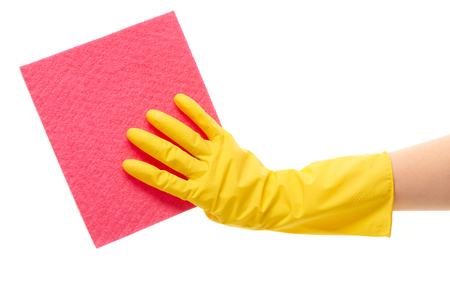 Close up of female hand in yellow protective rubber glove holding pink rag against white backgroundの写真素材