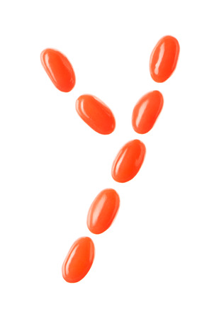 Y letter made of red candies isolated on white backgroundの写真素材