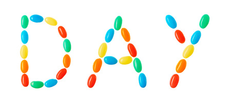 "day" lettering made of multicolord candies isolated on white backgroundの写真素材