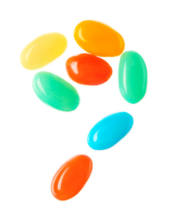 ?omma symbol made of multicolored candies isolated on white backgroundの写真素材