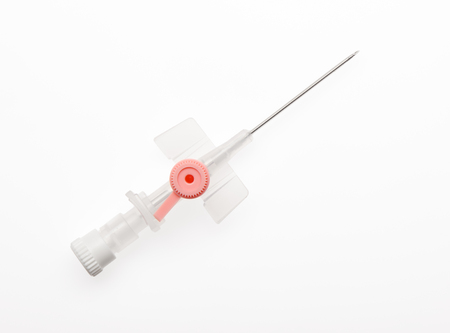 Pink plastic catheter with open needle isolated on white background.の写真素材