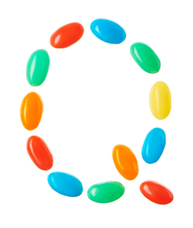 Q letter made of multicolored candies isolated on white backgroundの写真素材
