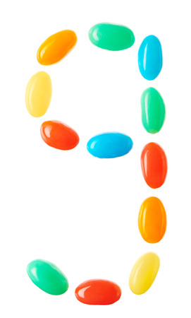 "9" number made of multicolored candies isolated on white backgroundの写真素材