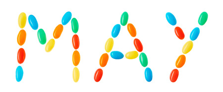 "may" lettering made of multicolored candies isolated on white backgroundの写真素材