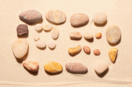 Airplane ticket from sea stones on sand. Summer beach background. View from aboveの写真素材