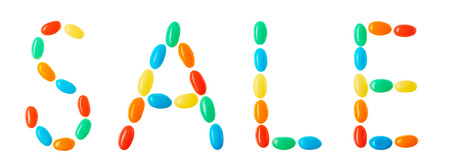 "sale" lettering made of multicolored candies isolated on white backgroundの写真素材