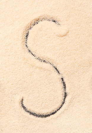S letter written on sandの写真素材