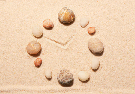 Watch from sea stones on sand. Summer beach background. View from aboveの写真素材