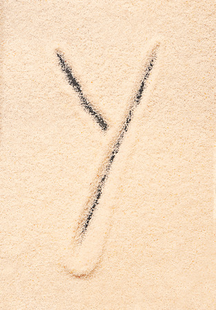 Y letter written on sandの写真素材