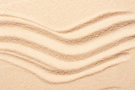 Beach sand with marks of waves. Summer beach background. View from aboveの写真素材