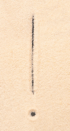 Exclamation mark symbol written on sand. Summer beach backgroundの写真素材