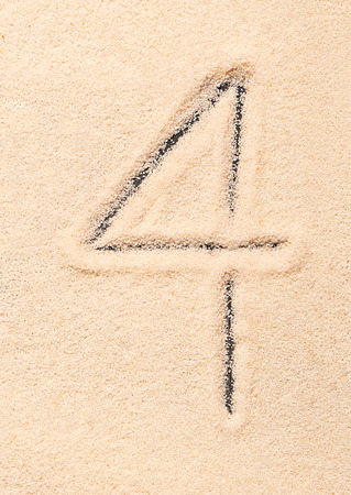 4 number written on sand. Summer beach backgroundの写真素材