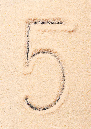 5 number written on sand. Summer beach backgroundの写真素材