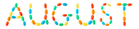 August lettering made of multicolored candies isolated on white backgroundの写真素材
