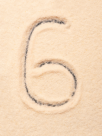 6 number written on sand. Summer beach backgroundの写真素材