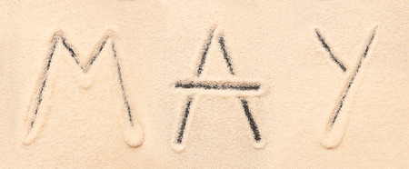 May lettering drawn on sand. Summer beach backgroundの写真素材