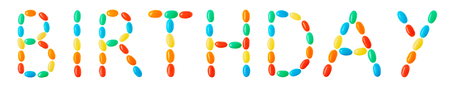 Birtday lettering made of multicolored candies isolated on white backgroundの写真素材