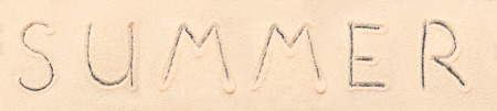 Summer lettering drawn on sand. Summer beach backgroundの写真素材