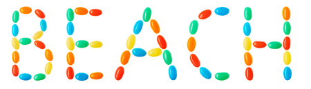 Beach lettering made of multicolored candies isolated on white backgroundの写真素材