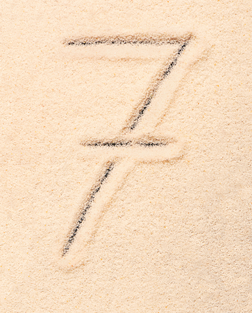 7 number written on sand. Summer beach backgroundの写真素材
