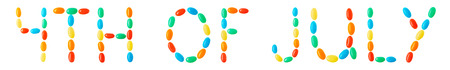 4th of July lettering made of multicolored candies isolated on white backgroundの写真素材