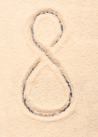 8 number written on sand. Summer beach backgroundの写真素材